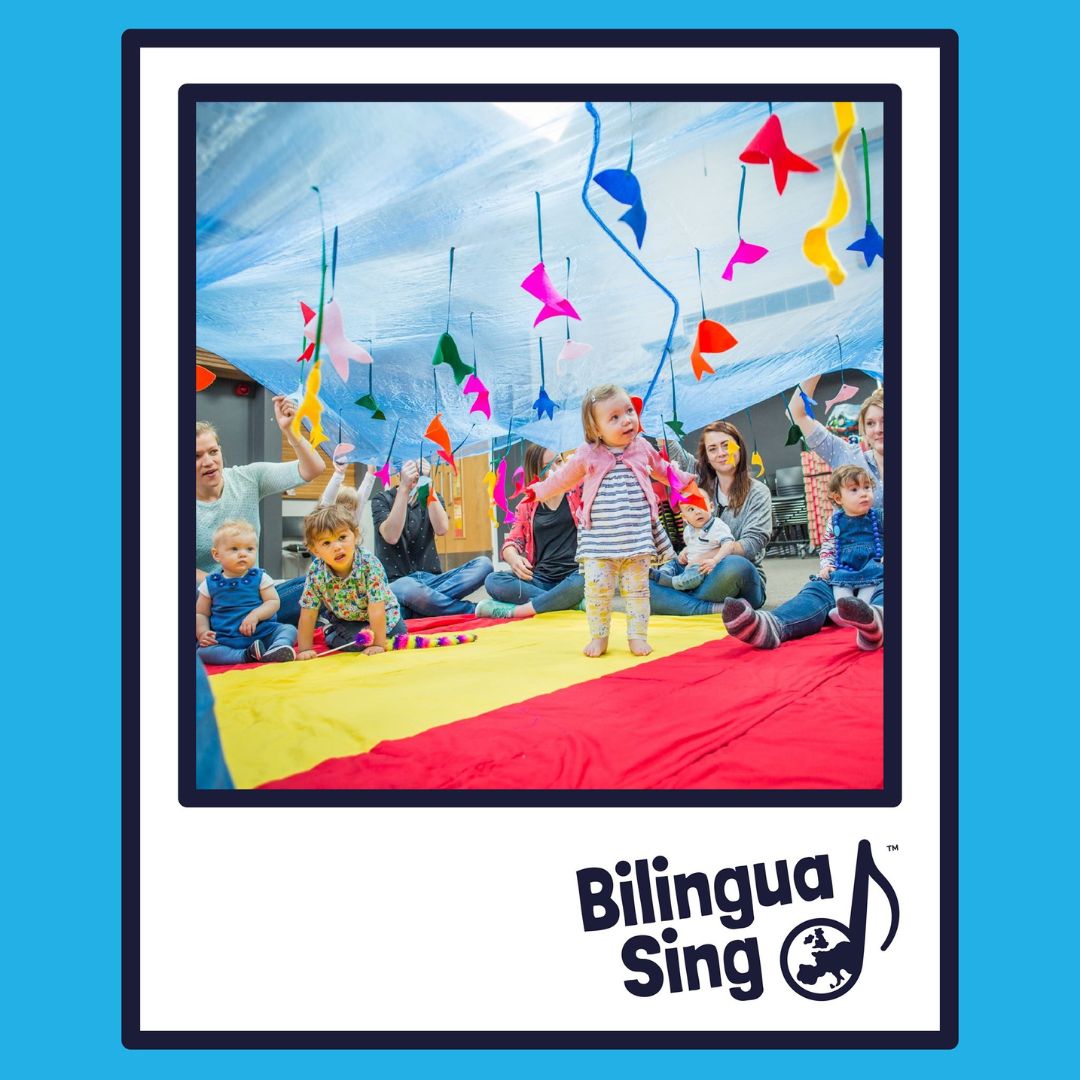 Young children enjoy a fun activity session with a parachute game at MFL teaching franchise BilinguaSing