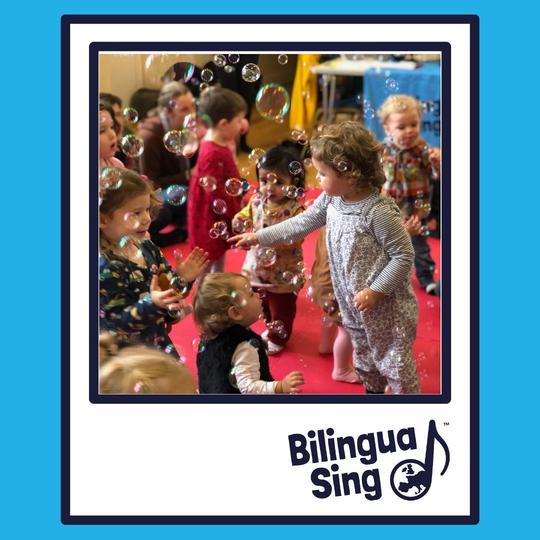 Young children enjoy a fun bubble game as part of a MFL teaching session at BilinguaSing franchise