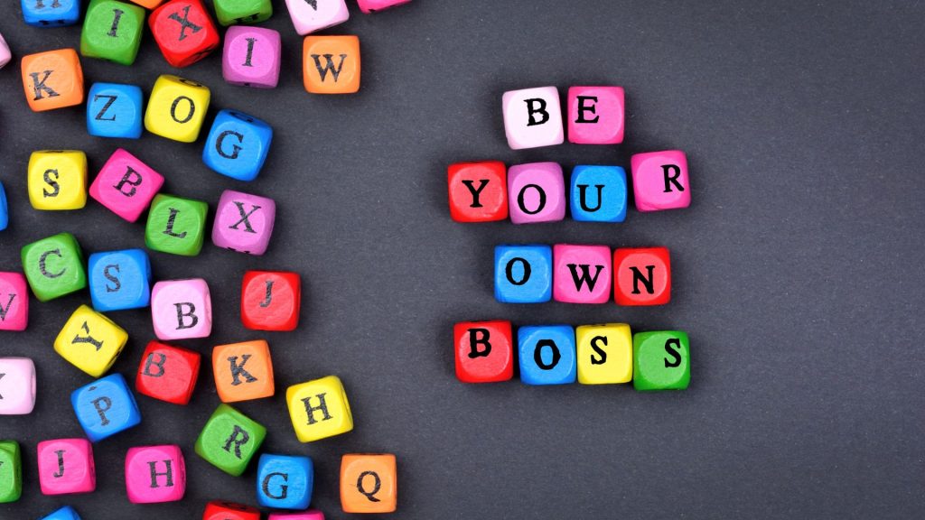 Colourful alphabet blocks are laid out with the wording BE YOUR OWN BOSS spelt out to represent this blog about why buying a franchise is a brilliant option rather than starting a business from scratch