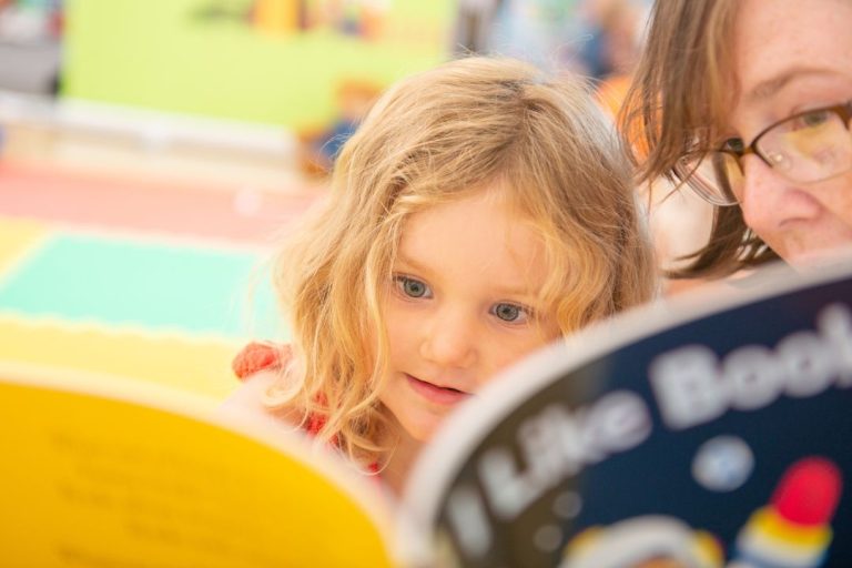 Photograph for education franchise business Reading Fairy showing a young girl enthralled by a storybook