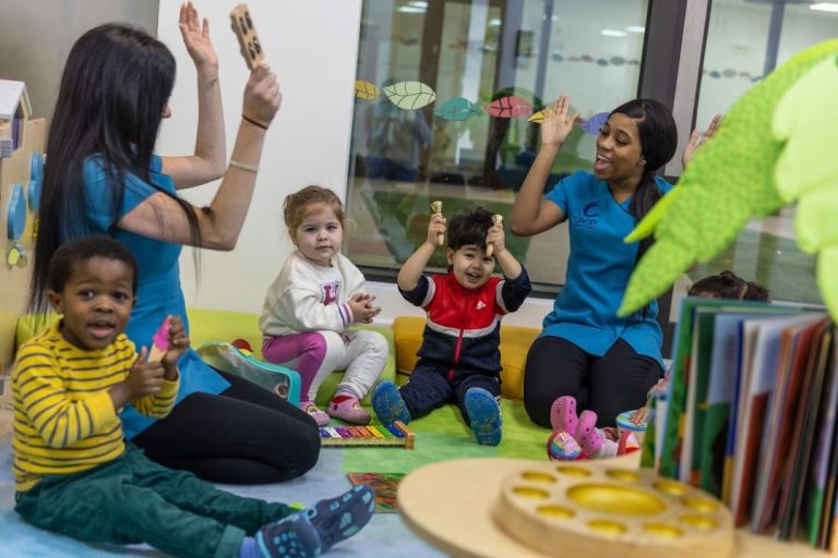 Activity leaders sing songs and play musical instruments with the young children at one of the branches of Canopy Children's Nurseries