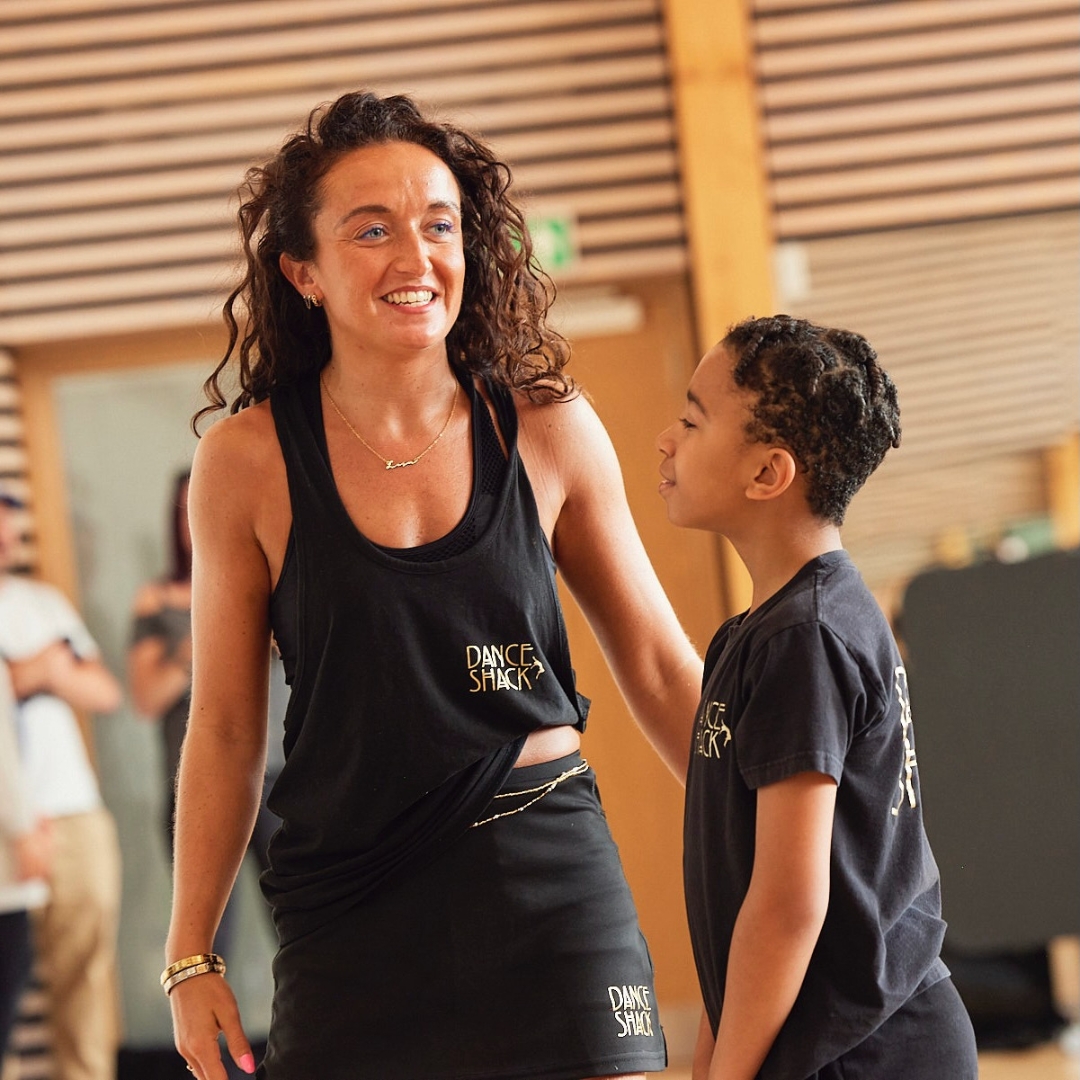 A young student works with a teacher in a dance studio to represent the UK children's performing arts franchise Dance Shack