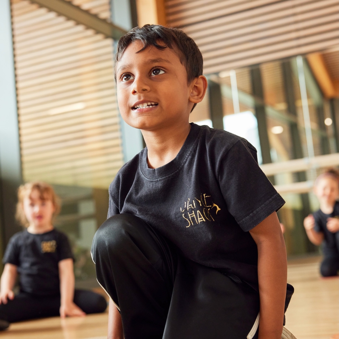A young boy enjoys a class in a dance studio to represent Dance Shack the children's performing arts franchise