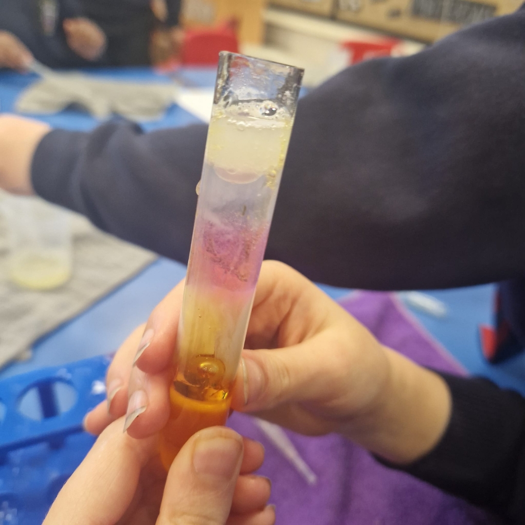 Close up on a bubbling test tube in an image to represent the LoveScience children's STEM franchise opportunity