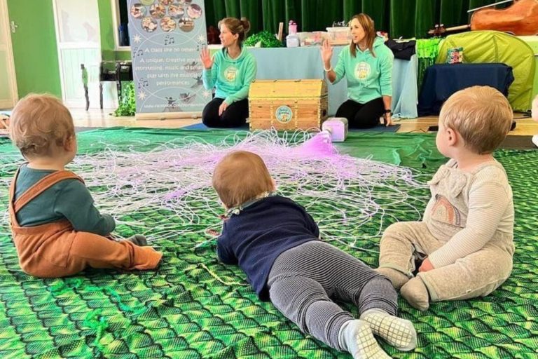 The leaders at sensory and music franchise Musical StoryBox sit in front of a group of toddlers with colourful and sensory props ready to share